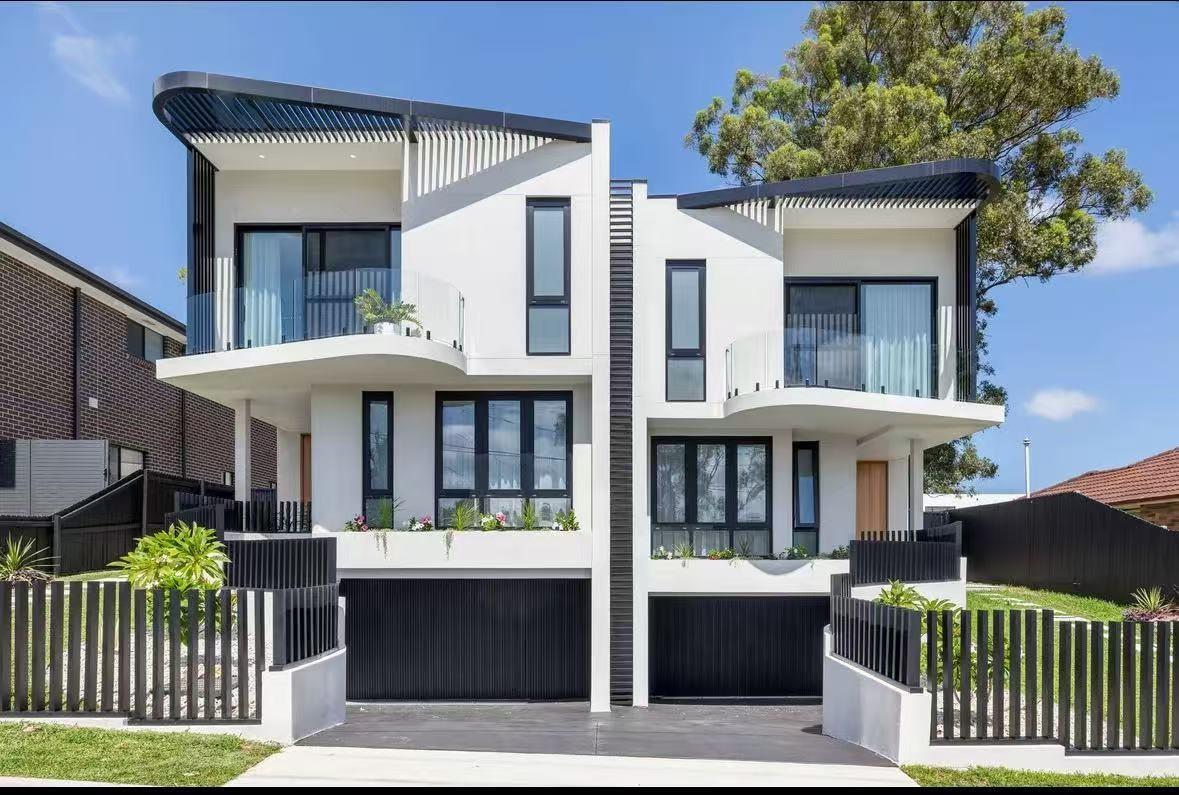 Two-storey rendered duplex with black-framed aluminium glazing